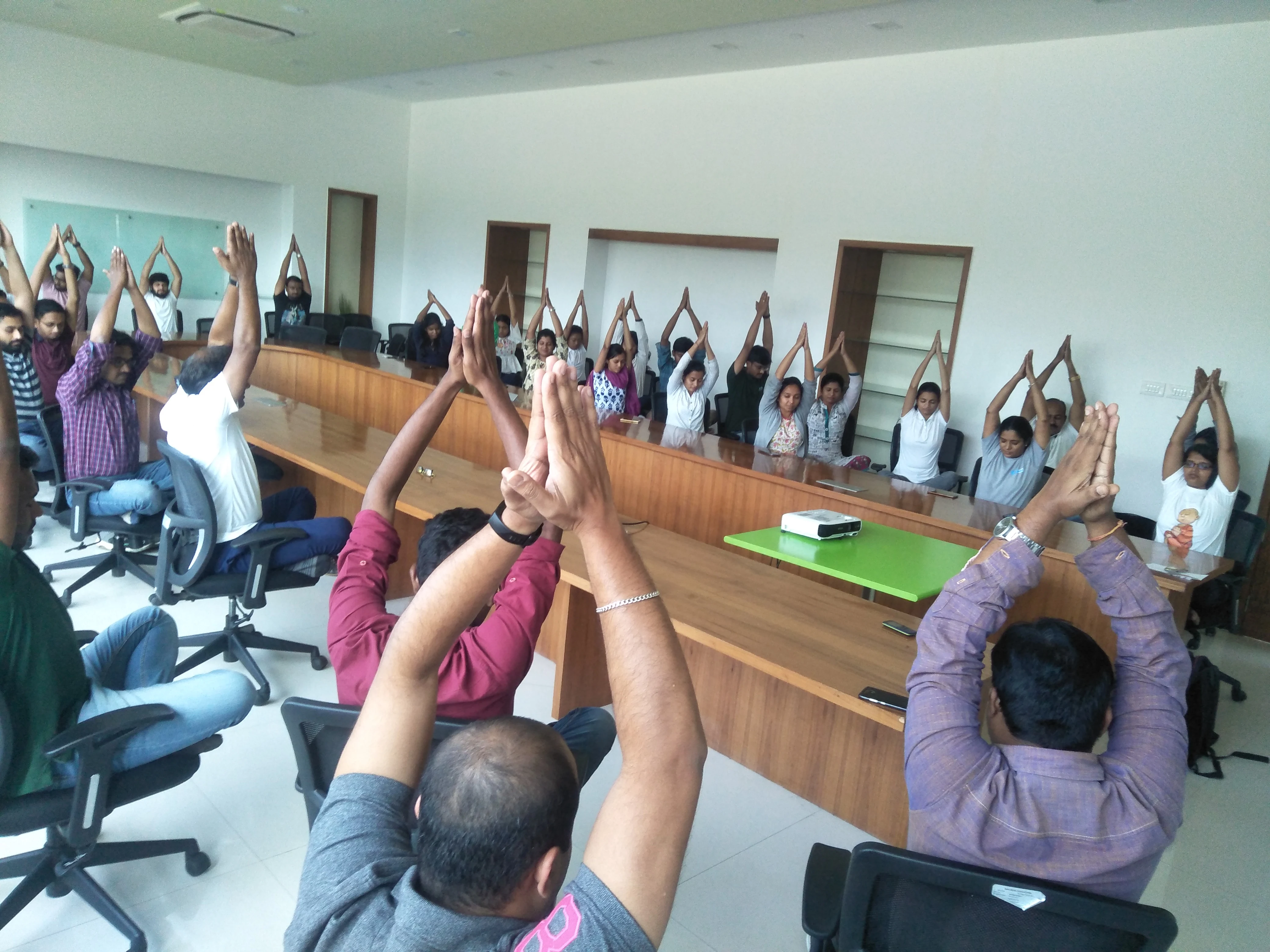 Students gathered for a yoga class in a bright, plant-filled studio