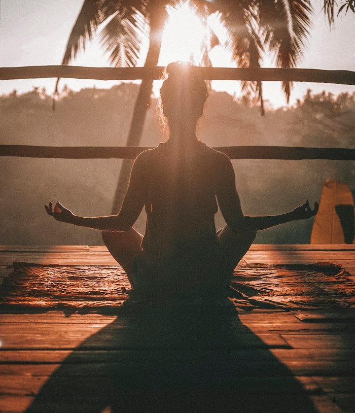 Students meditating together at sunset