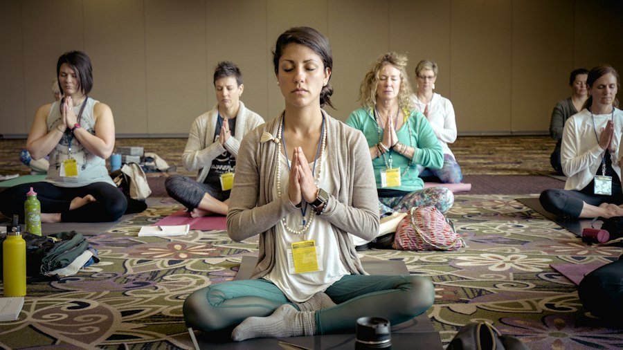 Beginners learning their first yoga postures